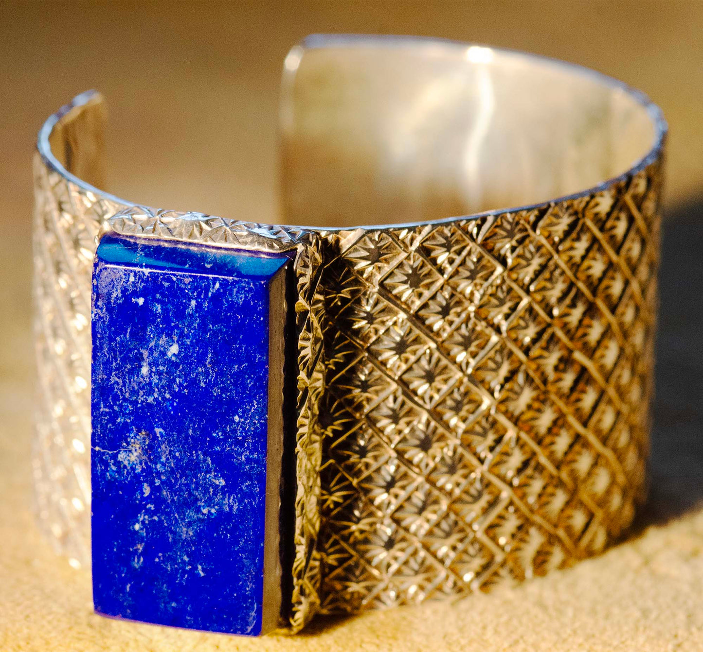 Sam LaFontain, Large Lapis Gem in a Handmade Silver Star Pattern Bracelet
